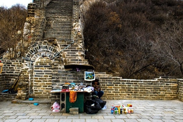 man sitting at the great wall of China