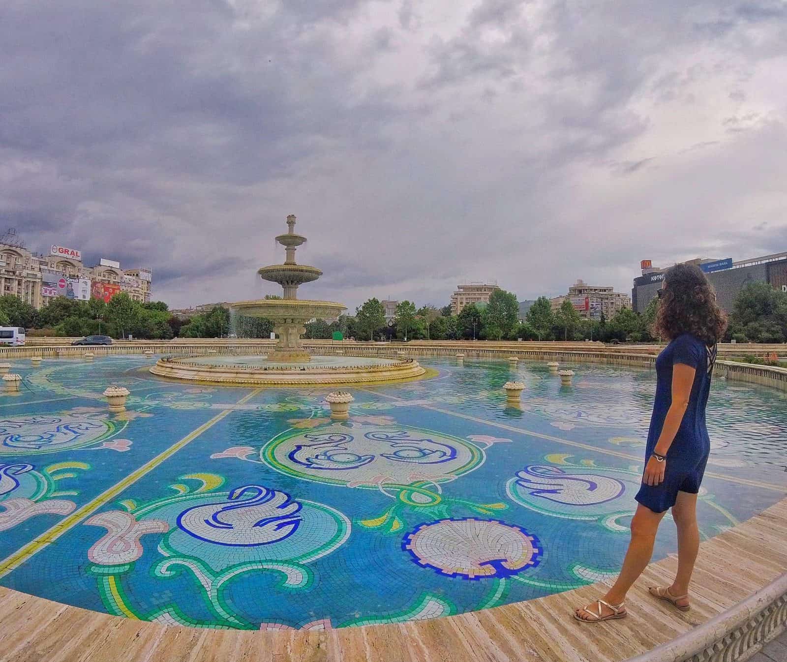 Nina standing at a huge city fountain in Bucharest, Romania.