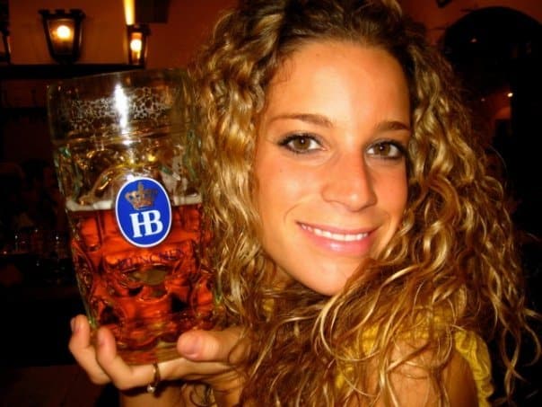 A younger Nina holding a huge stein of beer in Munich.