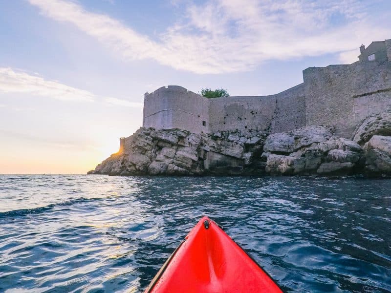 Kayaking Dubrovik's old walls on a group tour for your first time abroad