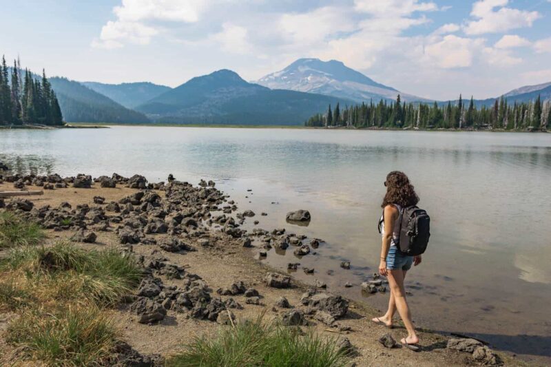 Anti theft backpack for women on woman's back along a lake