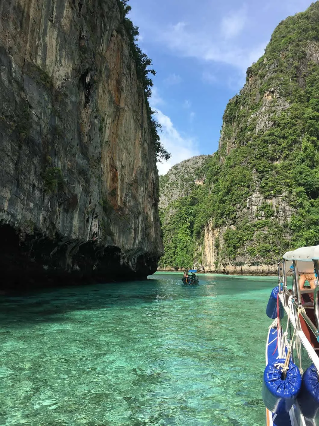 A POV of being on a boat between the limestone cliffs of Krabi.