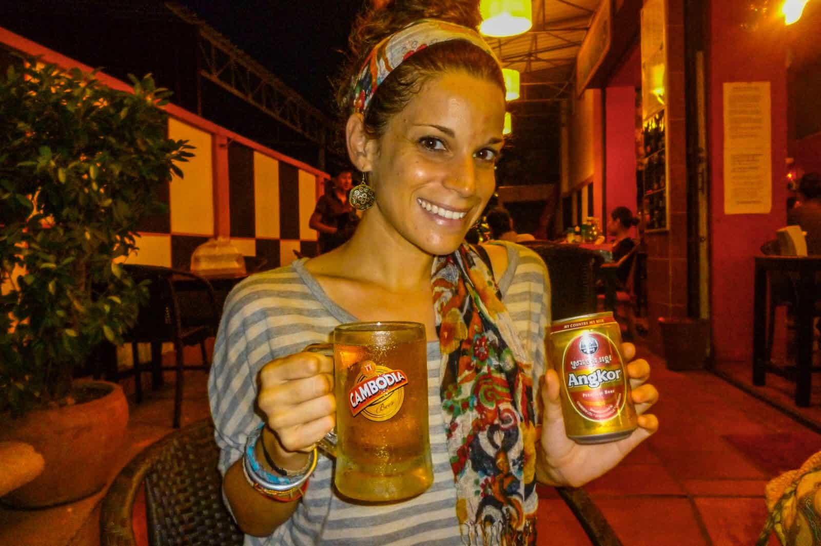 Nina in Cambodia while backpacking through Southeast Asia holding beer.
