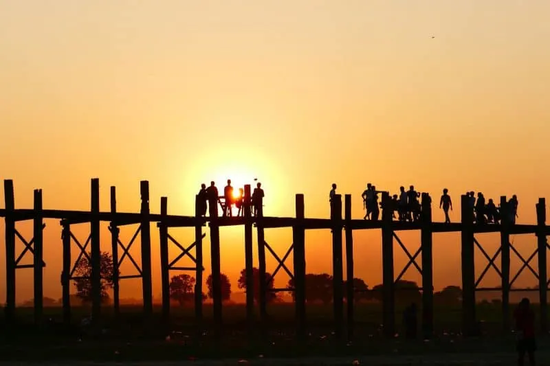 people on U Bein bridge during sunset