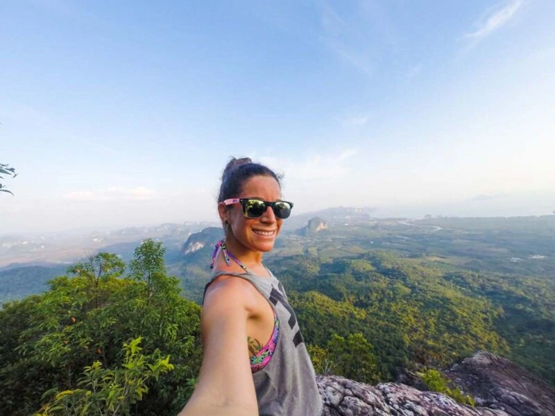 Woman hiker taking selfie with green landscape in Krabi