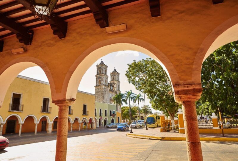 Colonial building viewed through arch in Valladolid - a must add to your Yucatan Itinerary