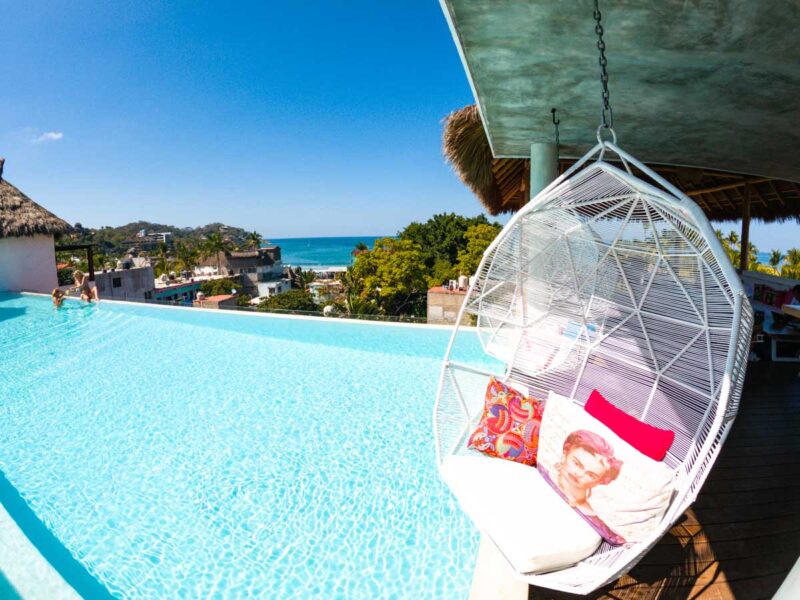 Hammock chair over pool with ocean in background at Sayulinda - hang here for the day for one of the things to do in Sayulita