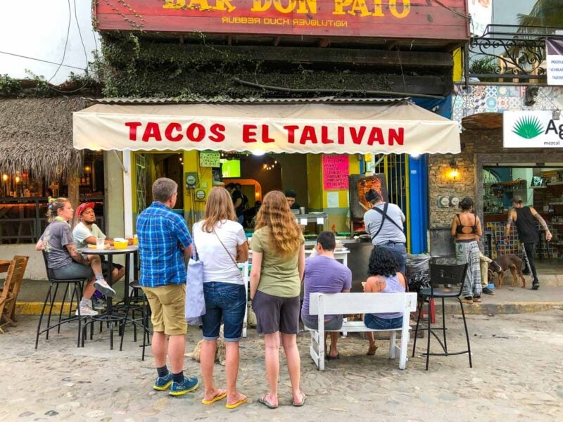 Group of people standing outside Tacos El Talivan - one of the top Sayulita Restaurants