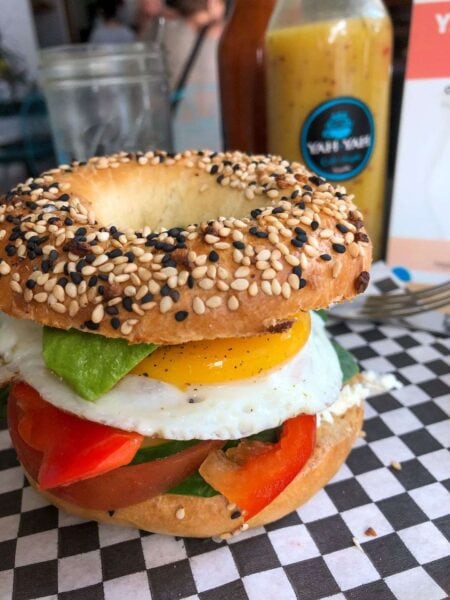 Breakfast bagel on chequered table at Yah Yahs on my list of where to eat in Sayulita