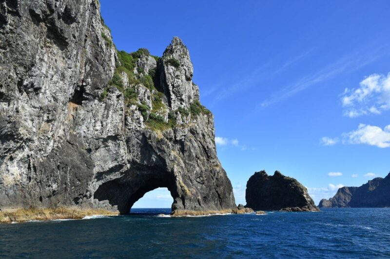 Hole in rock jutting out of the ocean in the Bay of Islands - one of the best things to do in Northland