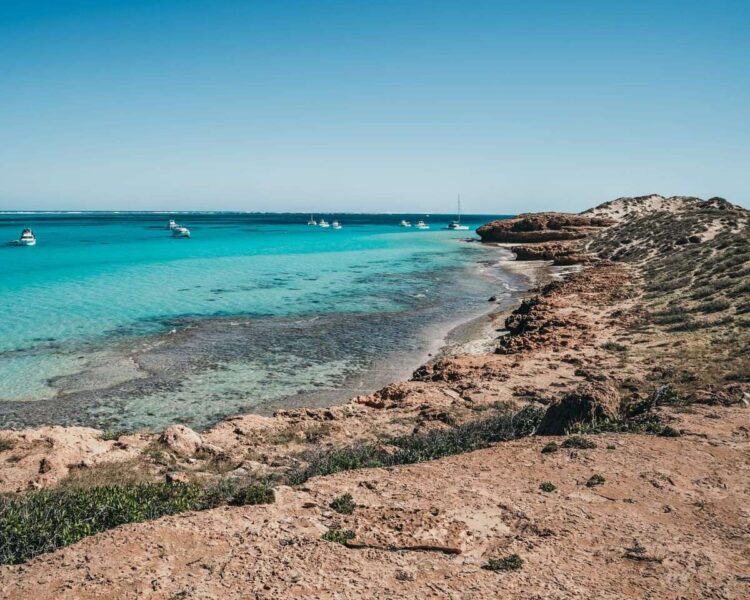 Rocky coastline with turquoise ocean - exploring the Coral Bay coast is one of the best things to do in Western Australia