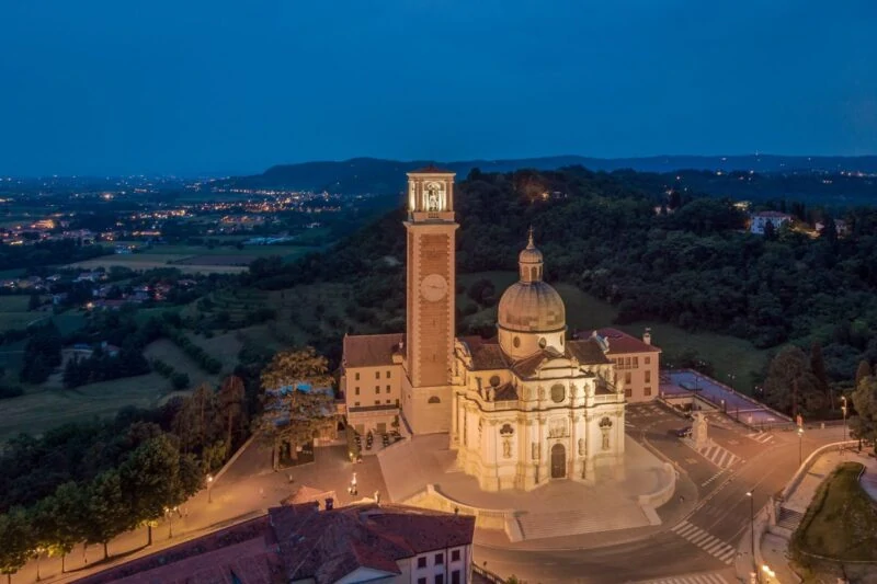 Monte Berico church lit up at night with countryside and city lights in background