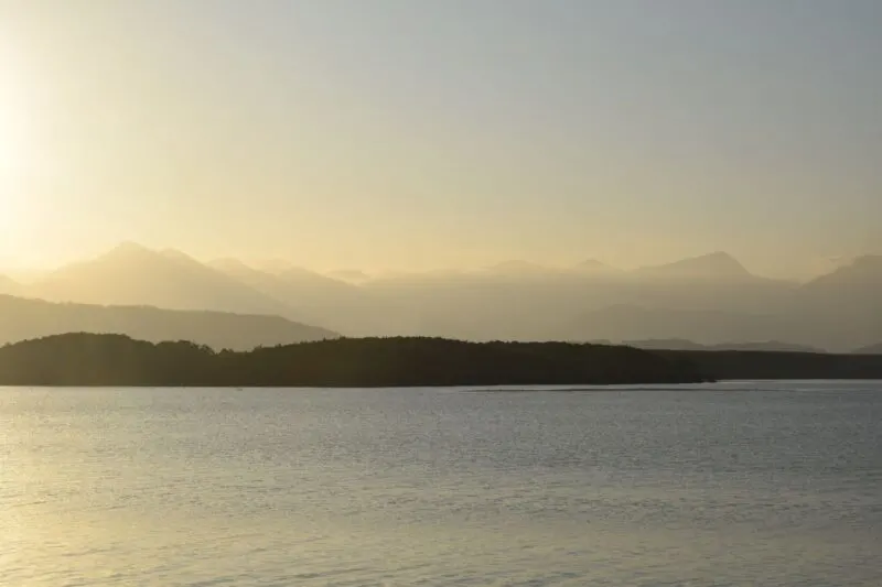 Sunset over ocean with headland in background at Port Douglas in Queensland