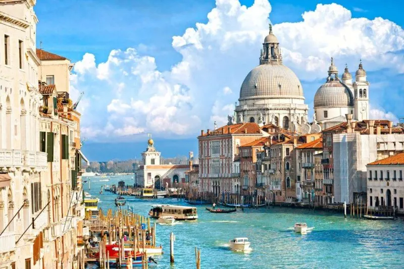 Grand Canal with historic buildings on each side on a sunny day in Venice