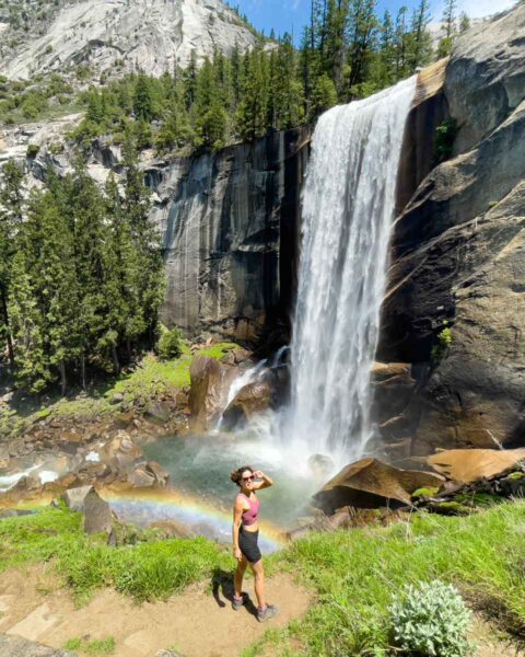 Hiker in front of rainbow at Vernal Falls in Yosemite National Park