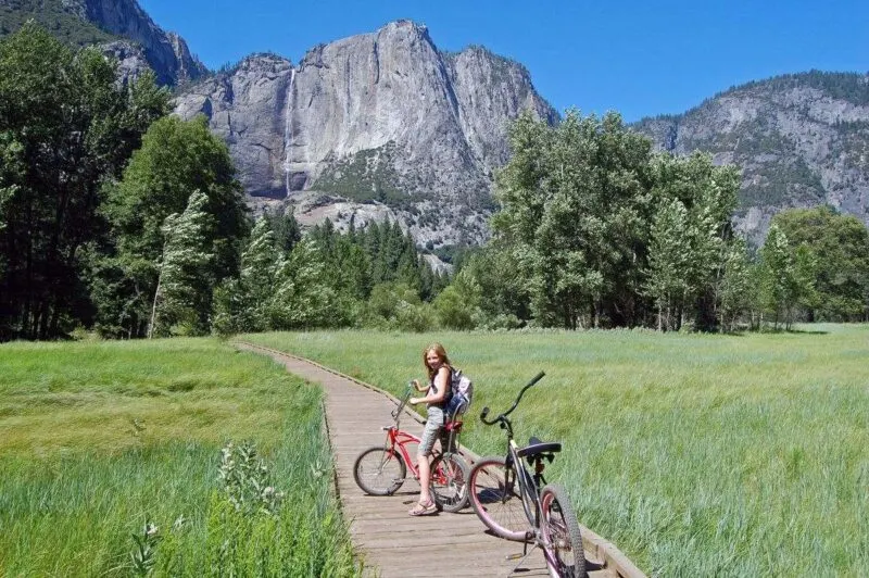 Woman cycling in front of mountains in Yosemite Valley
