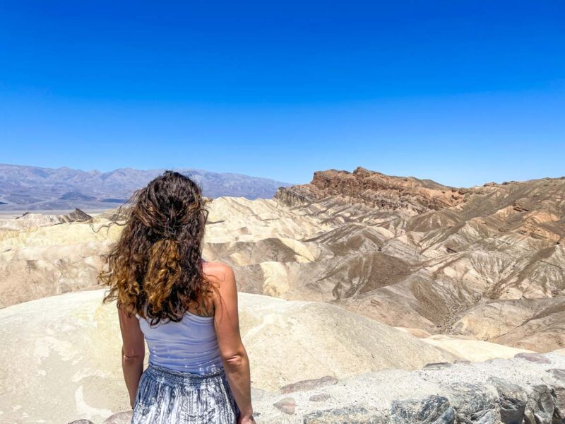 Woman looking over Death Valley from Zabrinski Point on a California road trip