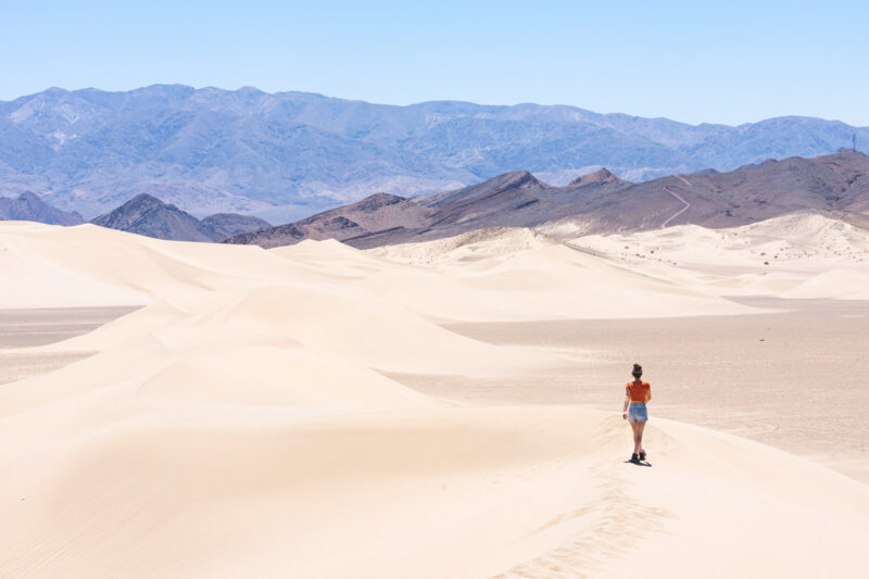 Woman walking across Dumont Dunes, California