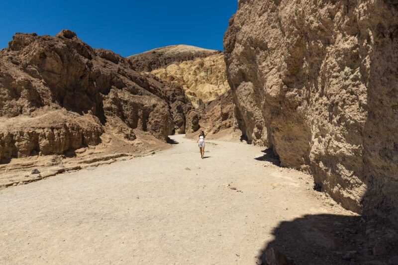 Woman walking though Golden Canyon in Death Valley, California