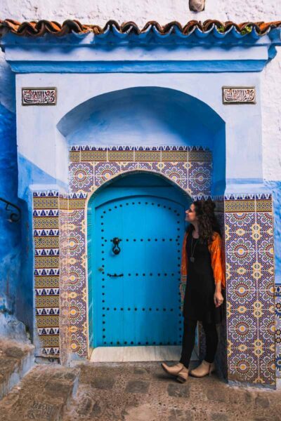 Me in a doorway in Chefchaouen, Morocco