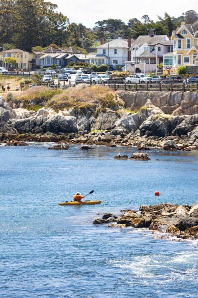 Kayaker in front of the town of Monterey, California