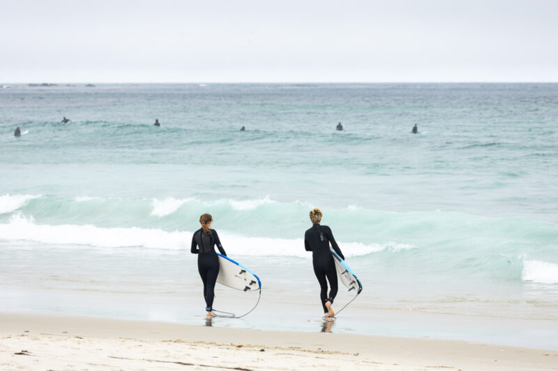 Surfers entering the water in Monterey