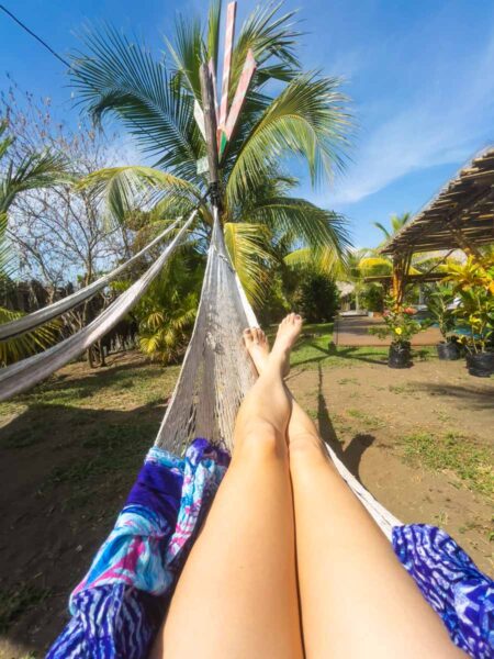 Person lying in hammock at Mellow Hostel, El Paredon