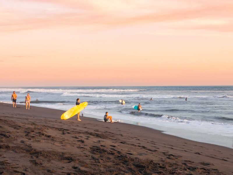 Surfers on the beach at El Paredon, Guatemala