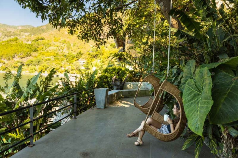 Woman in swing chair beside Lake Atitlan, Guatemala