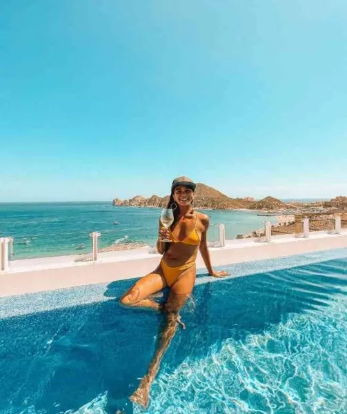 Woman in pool at beach club in Los Cabos cost of living in Mexico