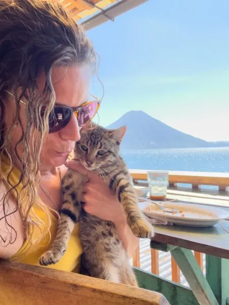Woman and cat at Indigo restaurant on Lake Atitlan Guatemala