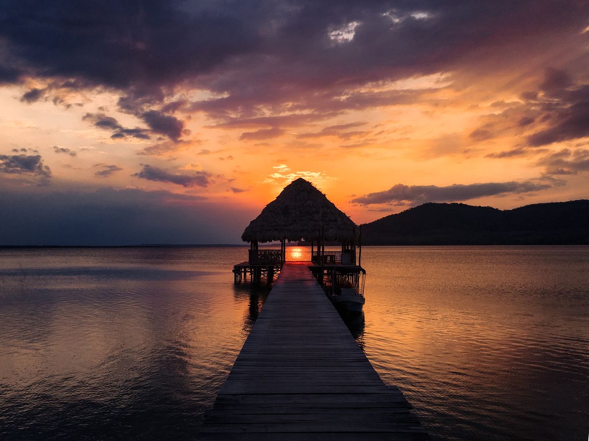 Hut on jetty at sunset in Tulum cost of living in Mexico