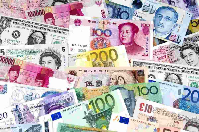 Pile of different currency notes top travel tips