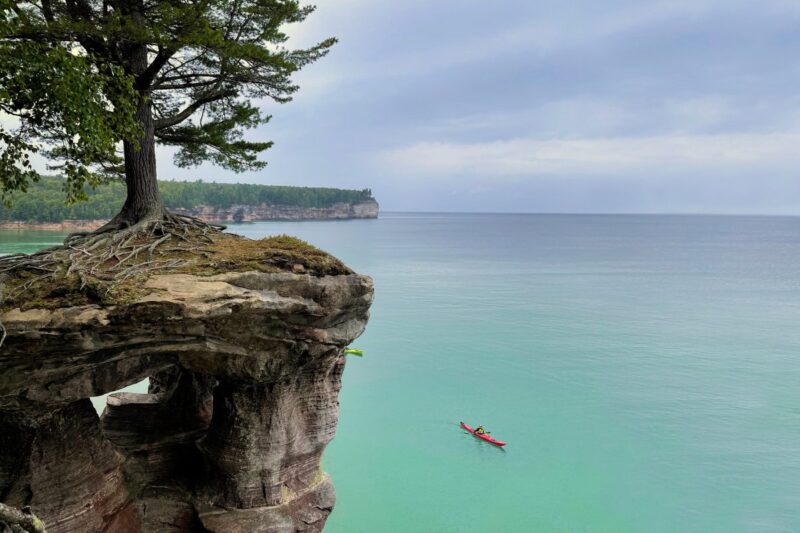 Kayak near cliff on Pictured Lakes National Lakeshore on hikes in Northern Michigan
