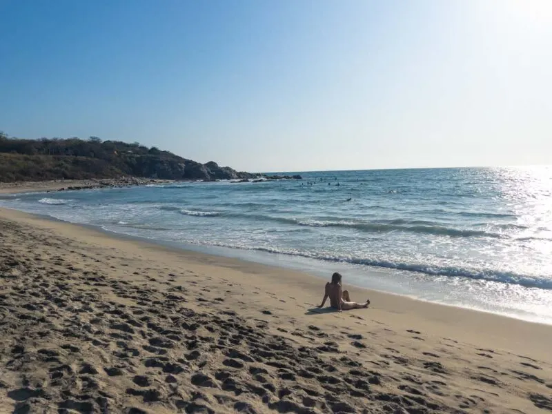 Person sitting on La Punta Zicatela beach