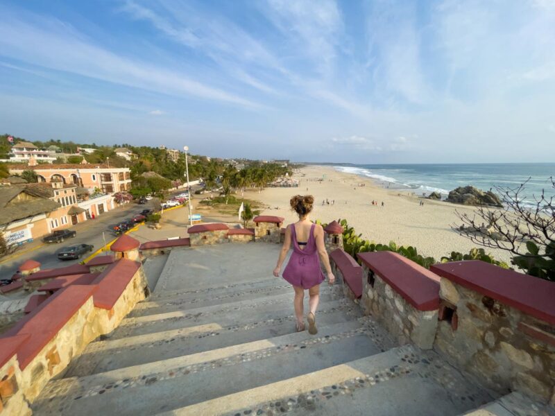 Woman walking down steps to Playa Zicatela