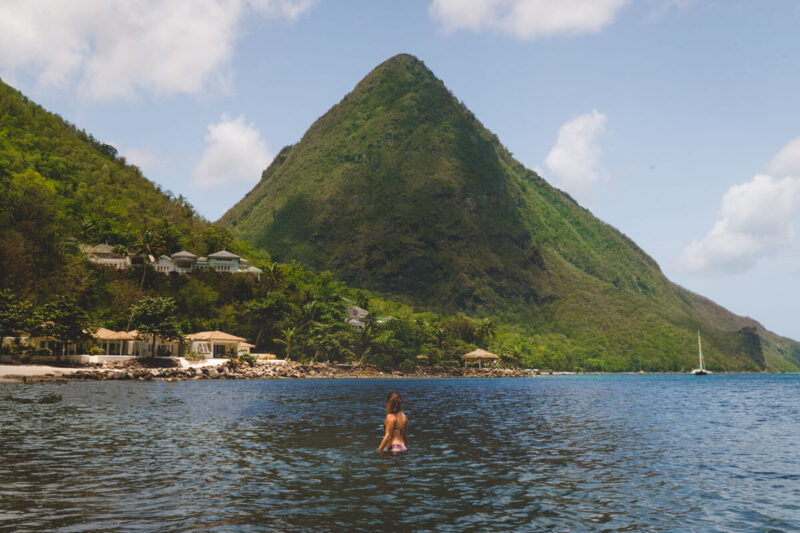 Woman swimming in front of Pitons things to do in St Lucia