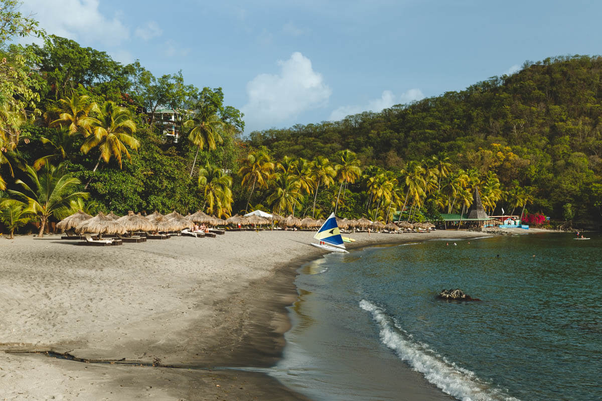 Anse Chastanet Beach in St Lucia with a little sailboat on the sand.