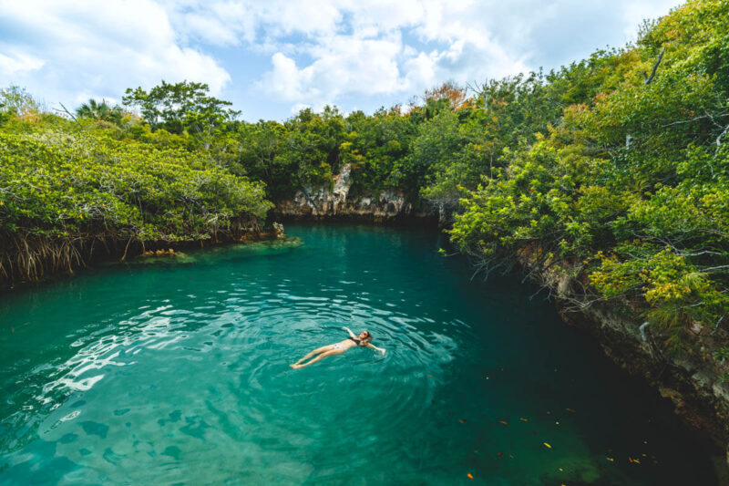 Woman swimming in Blue Hole Park things to do in Bermuda