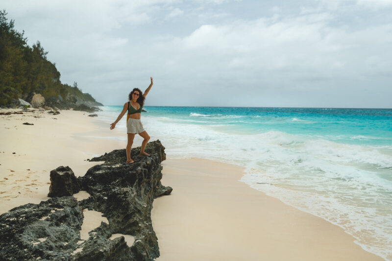 Woman on rock at Marley Beach things to do in Bermuda