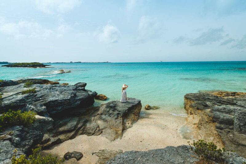 Woman on rock at Spanish Point Park things to do in Bermuda