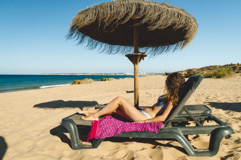 Woman on sunlounger on Praia da Gale, Algarve beaches
