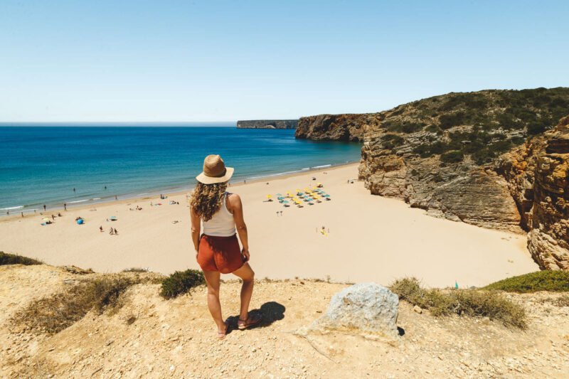 Woman overlooking Praia do Beliche, on an Algarve itinerary