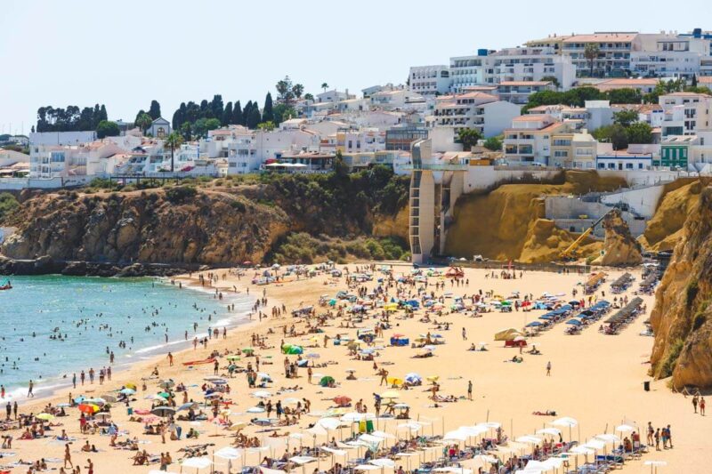 Crowds at Praia do Tunel one of the best beaches in Albufeira.