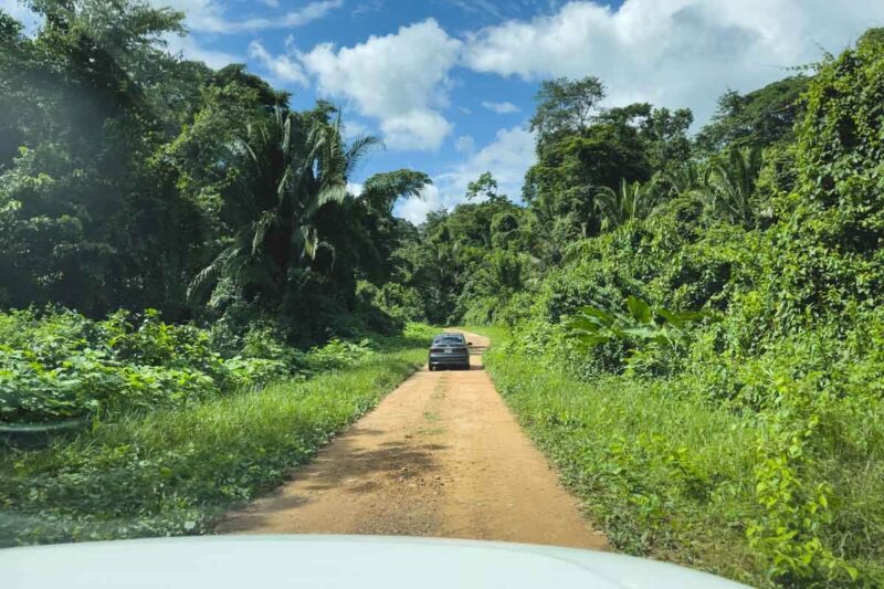 Driving on dirt road to things to do in Belize.