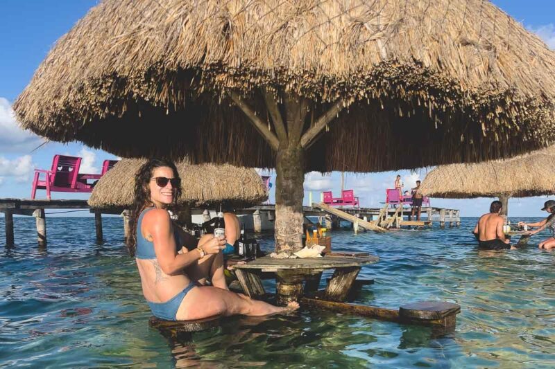 Tables in water at Sip n Dip Bar one of the best things to do in Belize