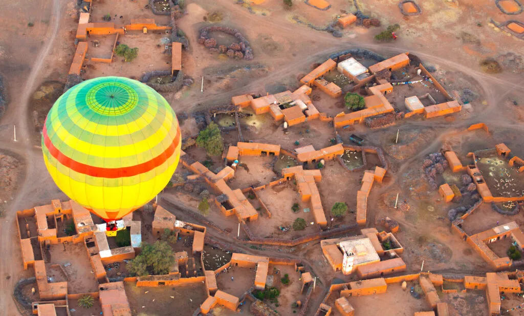 Aerial view of hot air balloon over town one of the day trips from Marrakech