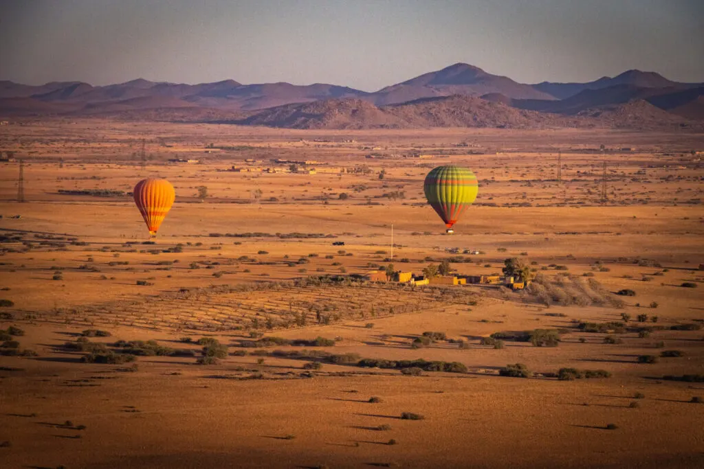 Hot air balloons over desert one of the best day trips from Marrakech