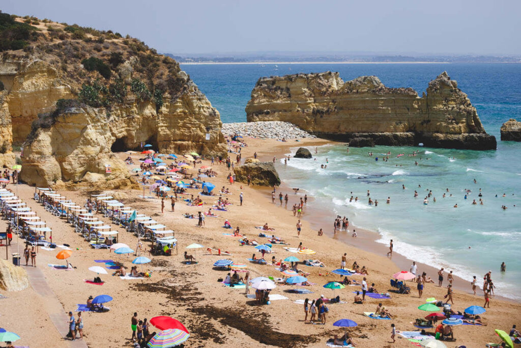 Be a part of the crowds on the beautiful beach at Praia Dona Ana in Lagos.