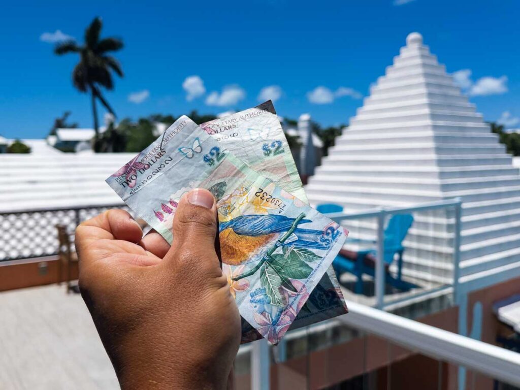 Man holding Bermudian money for things to do in Bermuda